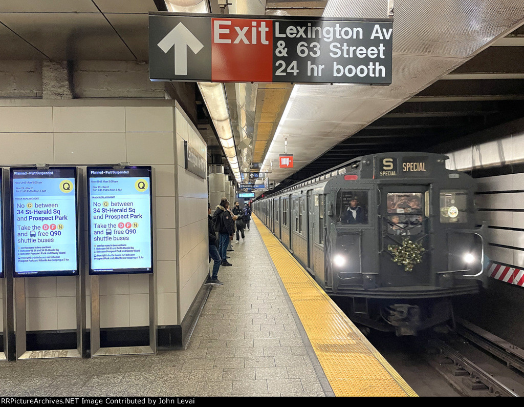 An early afternoon trip of the holiday train is about to depart Lexington Av-63 St Station.